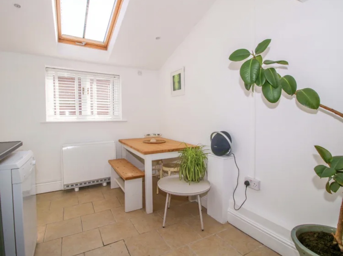 Bright dining nook with white walls and skylight