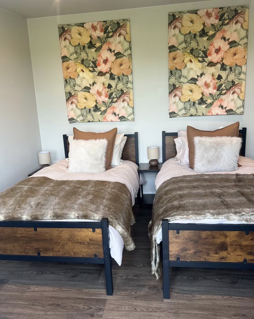 Twin beds beneath two floral wall panels
