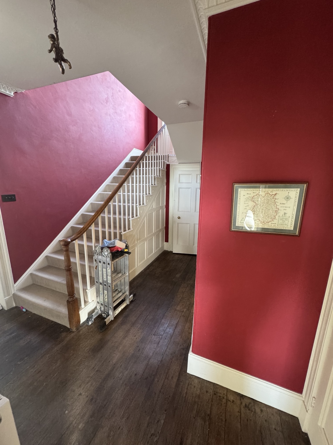 Entrance hall before, with deep red walls